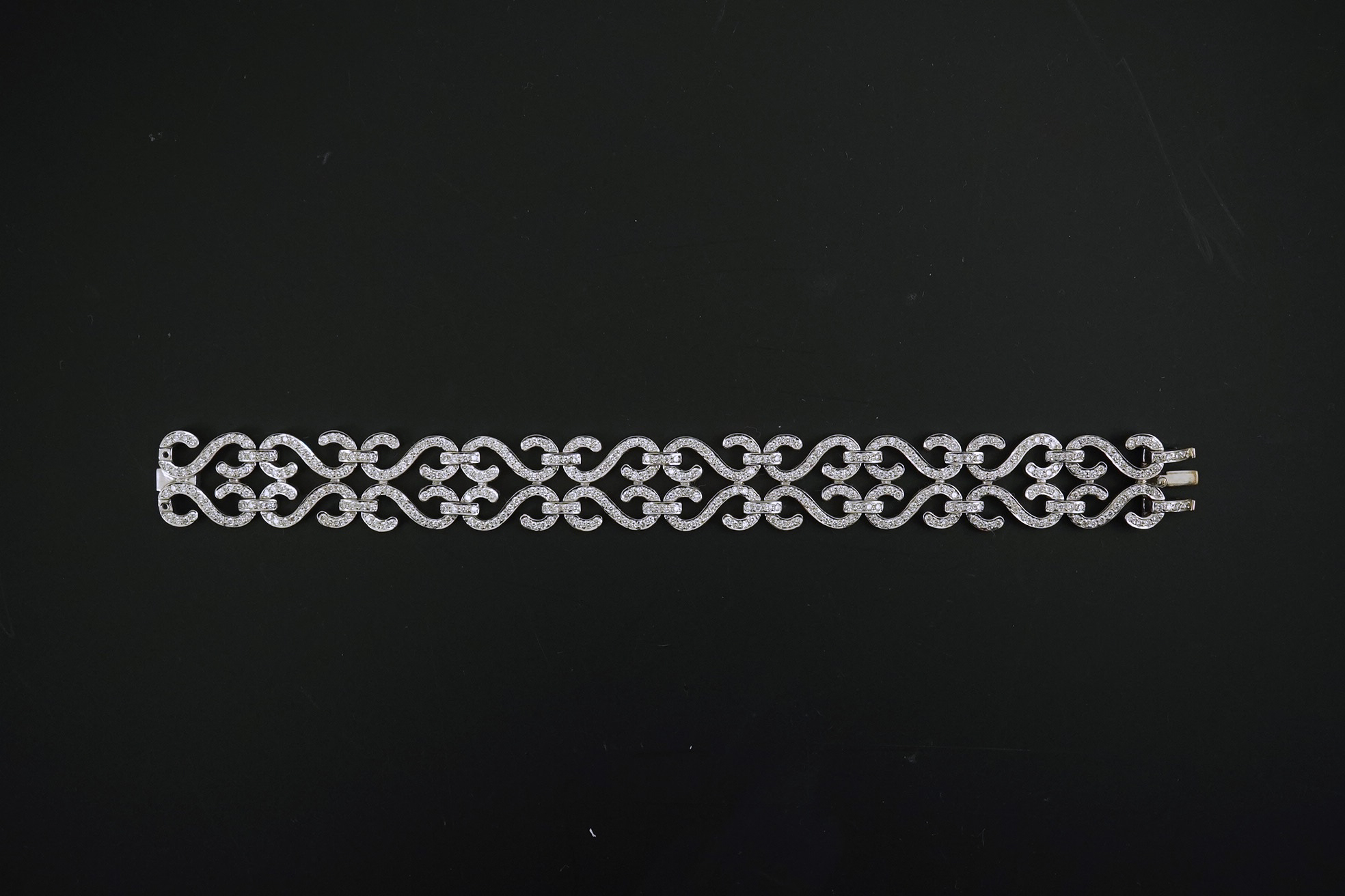 A modern 18k white gold and diamond chip cluster set bracelet